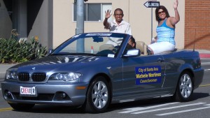 Alex Flores and Michele Martinez waving at the Fiestas Parade