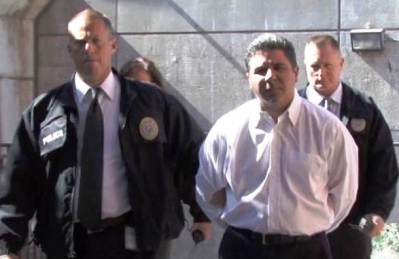 Carlos Bustamante dragged off in handcuffs