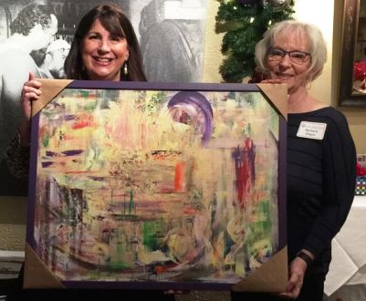 Crisis Residential Program Carol Carlson and Barbara Hagen hold a painting by Barbara Hagen