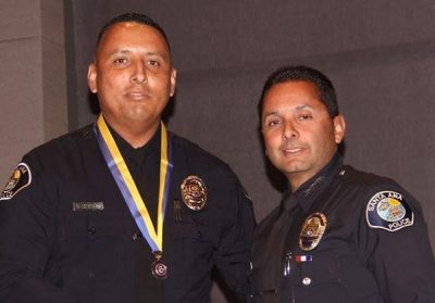 Chief Rojas (on the right) awarding the Medal of Valor to Officer Nelson Menendez