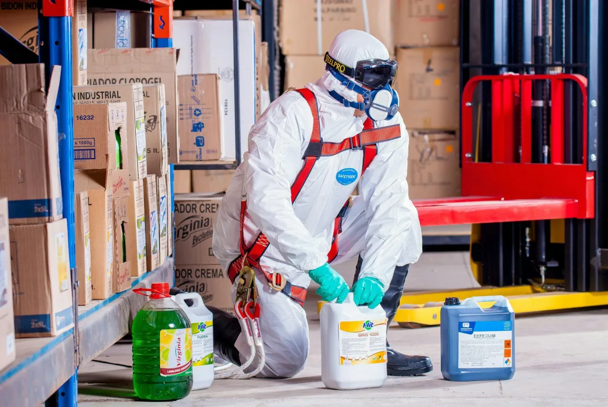 person wearing white suit holding white container